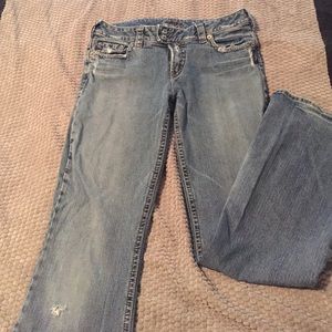 Distressed silver jeans