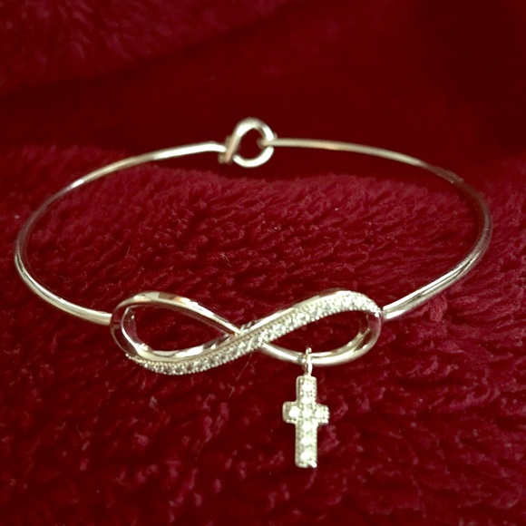Infinity bangle bracelet with hanging cross.