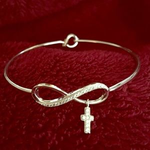 Infinity bangle bracelet with hanging cross.