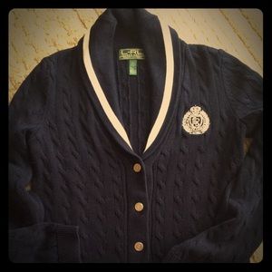 Ralph LaurenNavy blue/whiter sweater with emblem.