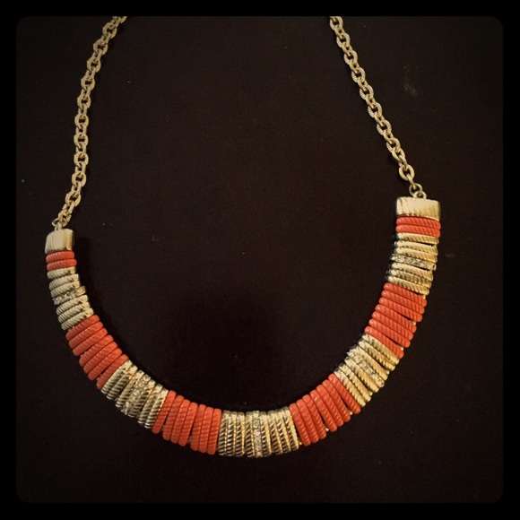 Orange and gold necklace with diamonds within.