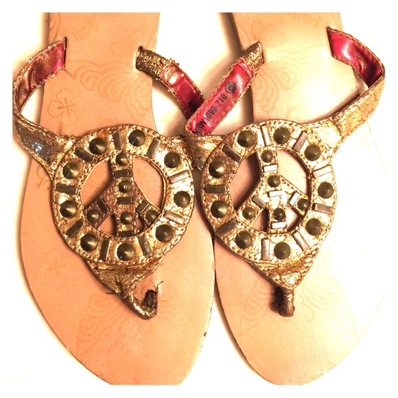 Not Rated gold peace sign sandals. Size 6.