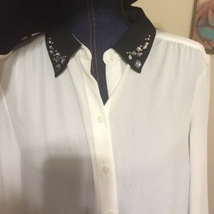 Cream blouse with black collar and jewels
