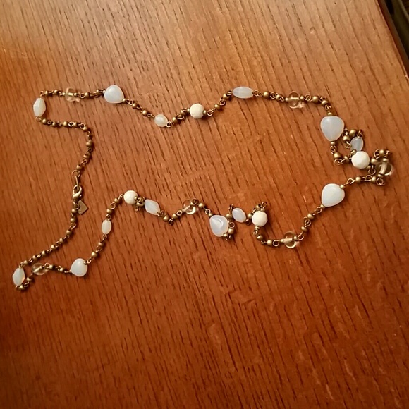 Gold colored chain with white and clear beads
