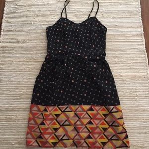 Black, tan, and orange dress with pockets. Small