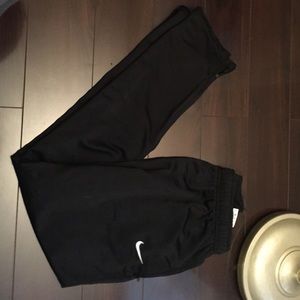 Black nike warm ups .