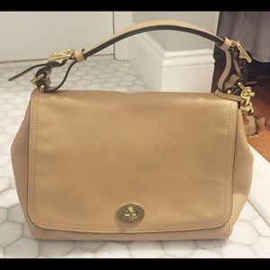 Beige Coach messenger bag in beige.