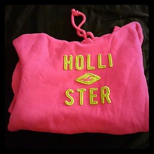 Pink hollister hoodie with green lettering