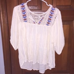 White, blue, red short sleeve shirt.