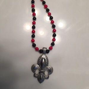 Silver, black and red Fluer-de-lis necklace .