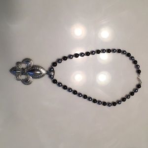 Black and silver Fleur-de-lis necklace .