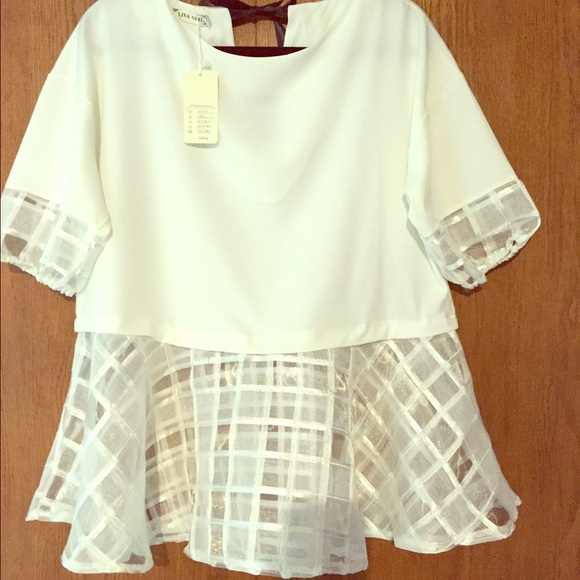 NWT off white silk blouse with black tie on neck.