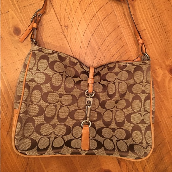 Coach canvas with leather trim & silver hardware.