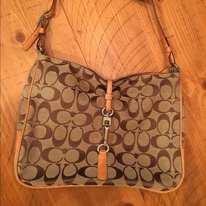 Coach canvas with leather trim & silver hardware.