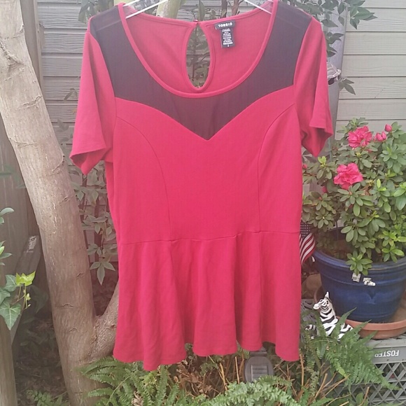 Red peplum top with black mesh across chest