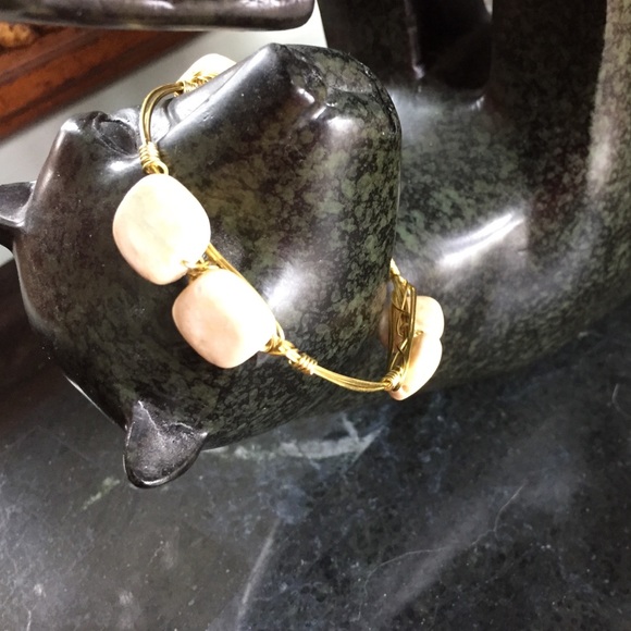 Gold tone wore wrapped bangle w/ riverstone beads.