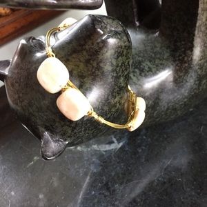 Gold tone wore wrapped bangle w/ riverstone beads.