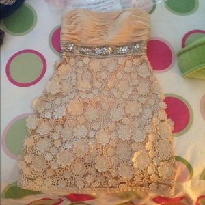 Short, cream colored dress with flower and beading