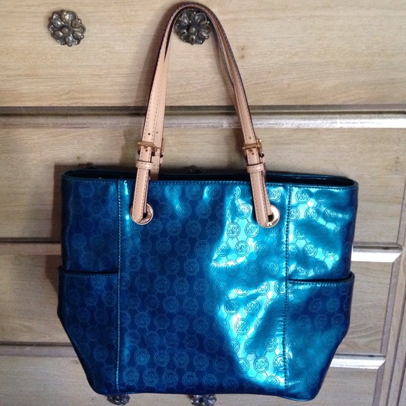 Big, dark green/turquoise Michael Kors purse.