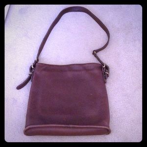 Coach. Brown leather thin single strap.