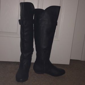 Over the knee black boots.
