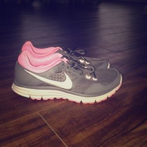 Gray and pink Nike tennis shoes