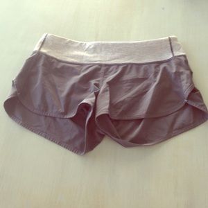 Grey lululemon workout shorts with white strips