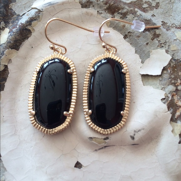 Jewelry - Sleek black earrings with gold tone hardware.