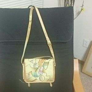 Hand painted leather Magnifique bag. Has built-in