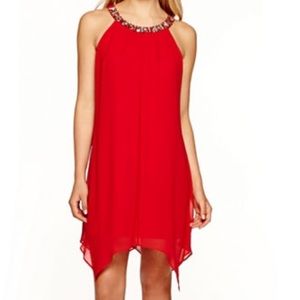 Red dress with silver necklace.