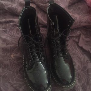 Black patent leather combat boots.