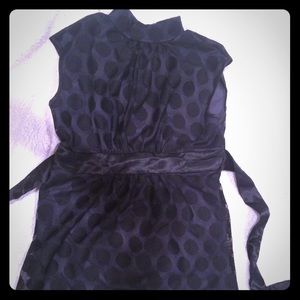 Black sleeveless polka dot top.