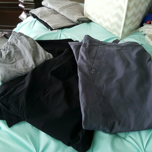 A group of 4 pair of work out bottoms