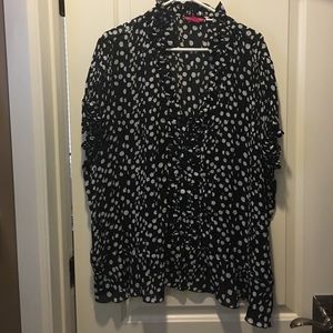 Polka dot sheer blouse with ruffle collar.