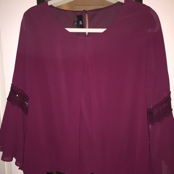 Bell sleeved top with lace detail.