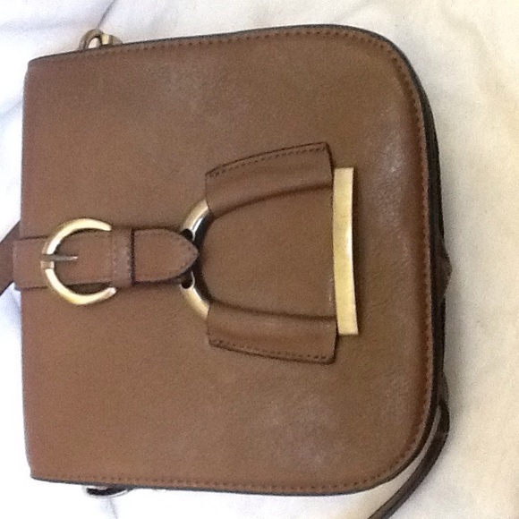 Brown leather saddlebag with brass horse stirup