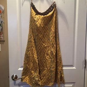 A long gold detailed skirt or tube dress.
