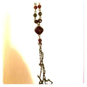 Long thin chain drape with ruby tassel necklace