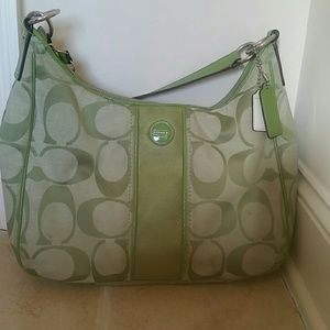 Green Coach Bag with slightly worn handle.
