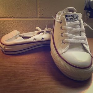 White shoveling Chuck Taylor's