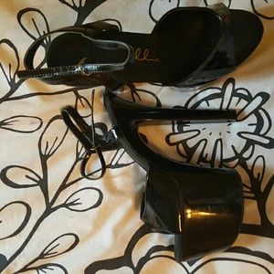 Black patent leather peep toe heels. Size 9.