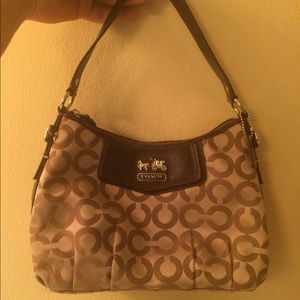 Small Coach purse with "c" design.