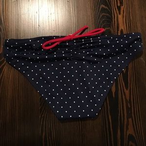 Polka dot bikini bottom with red bow
