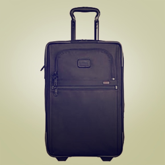 Dark green Tumi large suitcase.