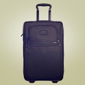 Dark green Tumi large suitcase.