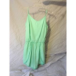 mint green romper with pom poms