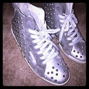Silver spiked tennis shoes