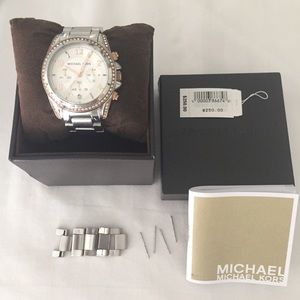 Michael Kors silver watch with rose gold accents.