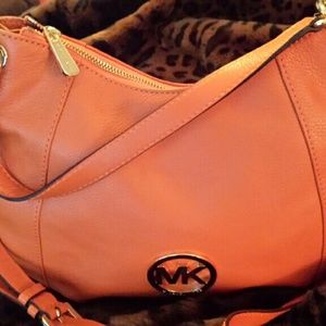 Tangerine colored Michael Kors shoulder bag.