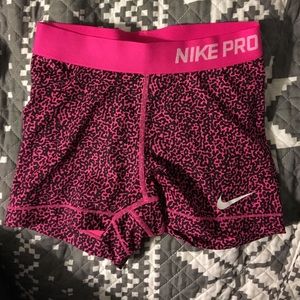 Black and pink nike pros